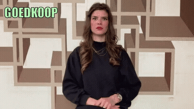 Woman Standing In Front Of Goedkoop Wall GIF