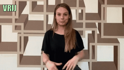 Woman Standing In Front Of Green Vrij Wall GIF