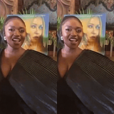 Woman Standing In Front Of Her Poster GIF