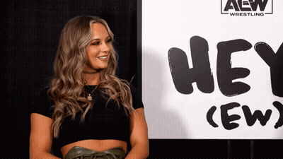 Woman Standing In Front Of Hey Crew Sign GIF