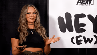 Woman Standing In Front Of Hey (Ew) Sign GIF