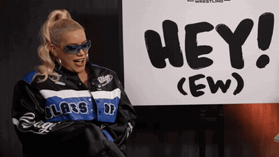 Woman Standing In Front Of Hey Sign GIF