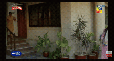Woman Standing In Front Of House With Mezan Paints Sign GIF