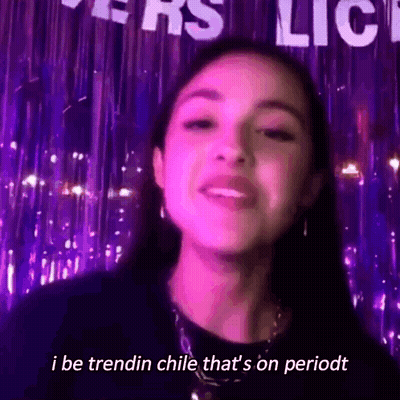 Woman Standing In Front Of I Be Trendin Chile Sign GIF