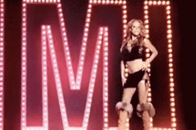 Woman Standing In Front Of LMC Sign GIF