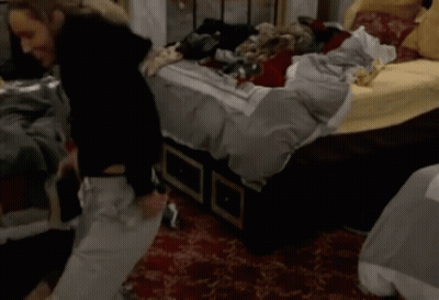 Woman Standing In Front Of Messy Bed GIF