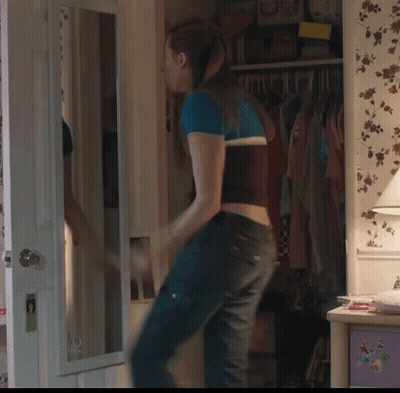 Woman Standing In Front Of Mirror In Bedroom GIF