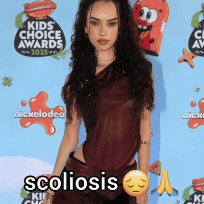 Woman Standing In Front Of Nickelodeon GIF