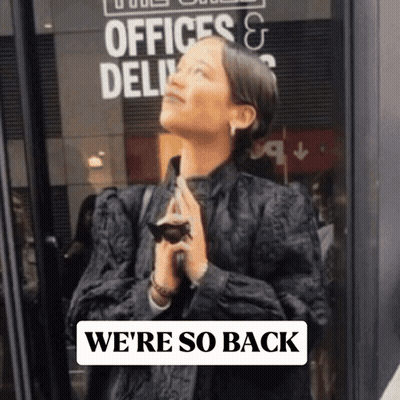 Woman Standing In Front Of Offices & Delivery Sign GIF