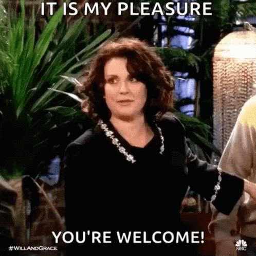Woman Standing In Front Of Plant Saying You're Welcome GIF