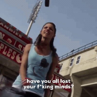 Woman Standing In Front Of Plesco Sign GIF