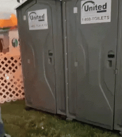 Woman Standing In Front Of Portable Toilet Saying United GIF
