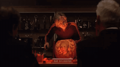 Woman Standing In Front Of Pumpkin With Sue Sylvester Picture GIF