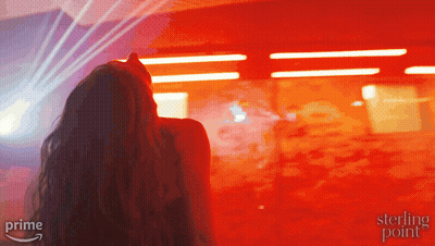 Woman Standing In Front Of Red Wall With Sterling Point GIF