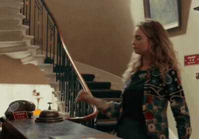 Woman Standing In Front Of Shower Tea Sign GIF