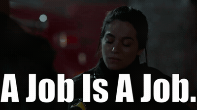 Woman Standing In Front Of Sign Saying A Job Is A Job GIF