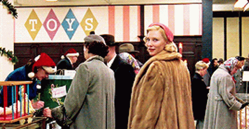 Woman Standing In Front Of Sign Saying Toys GIF