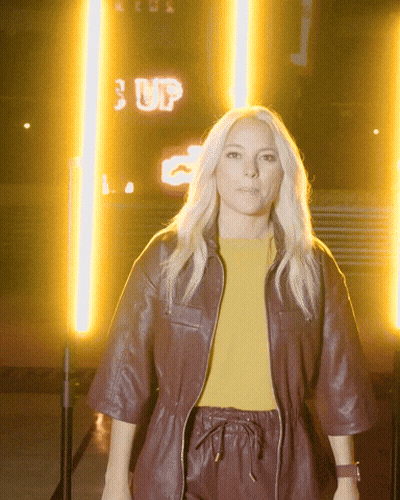 Woman Standing In Front Of Sign Saying Up GIF