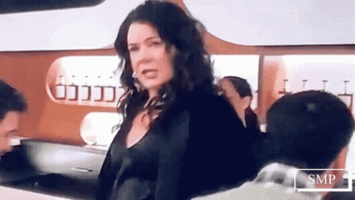 Woman Standing In Front Of SMP Sign GIF