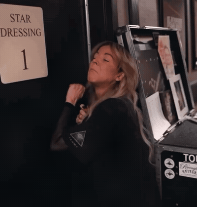Woman Standing In Front Of Star Dressing Sign GIF