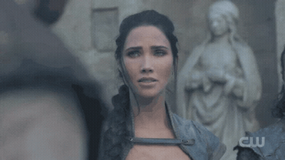 Woman Standing In Front Of Statue With Letters CW GIF