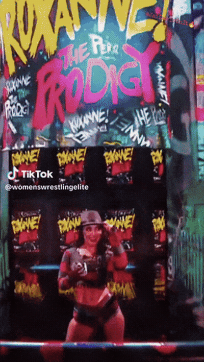 Woman Standing In Front Of The Pera Prodigy Sign GIF