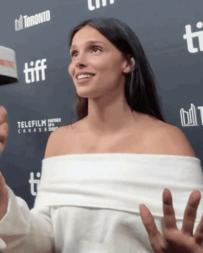 Woman Standing In Front Of Toronto TIFF Banner GIF