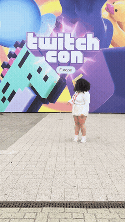 Woman Standing In Front Of Twitch Con Europe Sign GIF