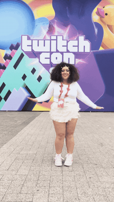 Woman Standing In Front Of Twitch Con Sign GIF