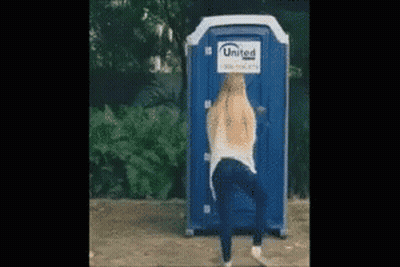 Woman Standing In Front Of United Portable Toilet GIF