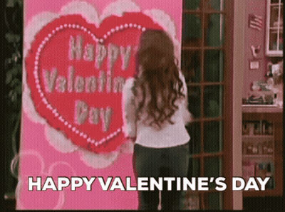 Woman Standing In Front Of Valentine's Day Card GIF