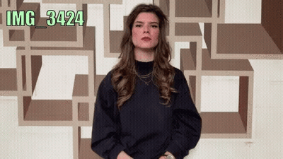 Woman Standing In Front Of Wall With Numbers IMG 34224 GIF