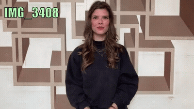 Woman Standing In Front Of Wall With Watermark Img_3402 GIF