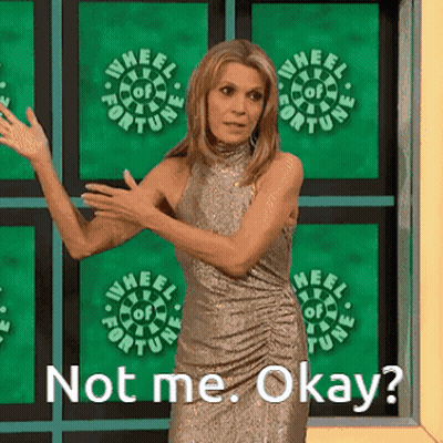 Woman Standing In Front Of Wheel Of Fortune Sign GIF