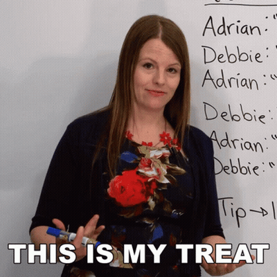 Woman Standing In Front Of Whiteboard Saying This Is My Treat GIF