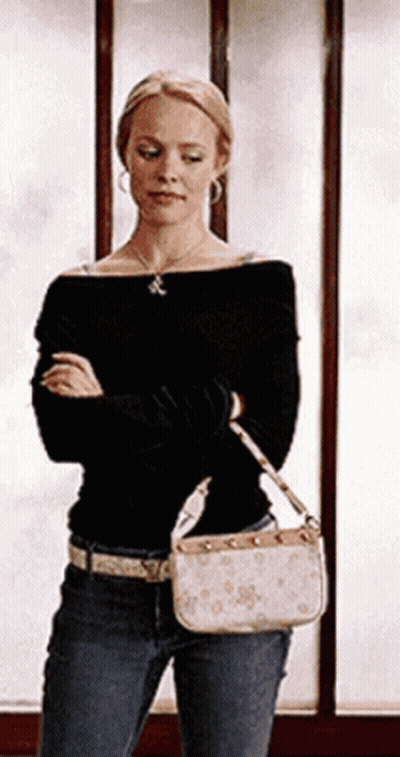 Woman Standing In Front Of Window Holding Purse GIF
