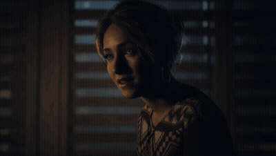 Woman Standing in Front of Window With Blinds