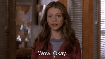 Woman Standing In Front Of Window With Blinds GIF