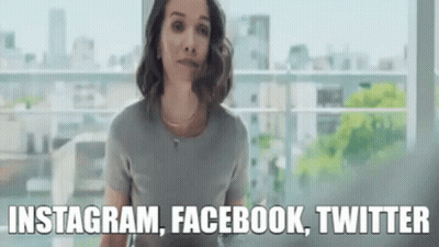 Woman Standing In Front Of Window With Instagram Facebook Twitter GIF