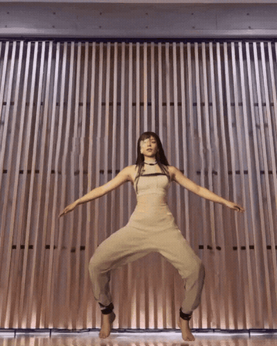 Woman Standing In Front Of Wooden Wall GIF