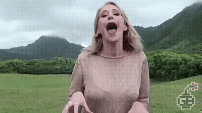 Woman Standing In Grassy Field Mouth Open GIF
