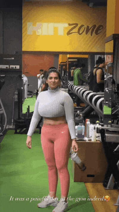 Woman Standing In Gym With Hitzone Sign GIF