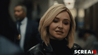 Woman Standing In Hallway With Scream GIF