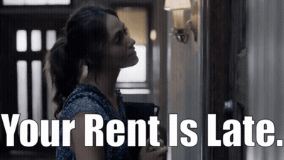 Woman Standing In Hallway With Your Rent Is Late GIF