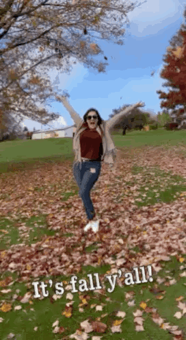 Woman Standing In Leaf Field With Arms Up GIF