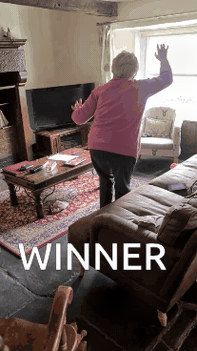 Woman Standing In Living Room With Winner GIF