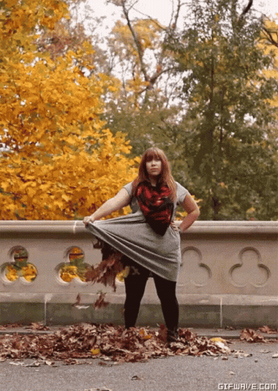 Woman Standing In Pile Of Leaves GIF