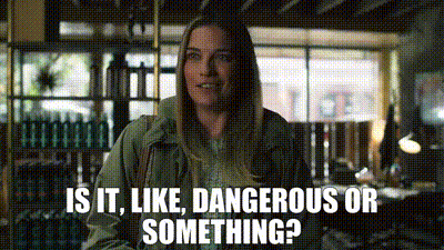 Woman Standing In Room Saying Is It Like Dangerous Or Something GIF