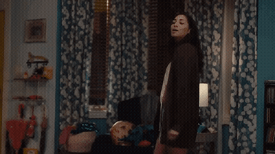 Woman Standing In Room With Lamp GIF