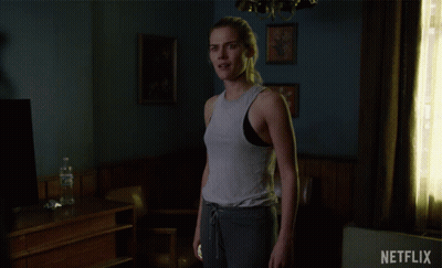 Woman Standing In Room With Netflix Logo GIF